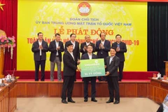 Chủ tịch HĐQT Vietcombank (giữa) trao biển tượng trưng số tiền ủng hộ công tác phòng, chống dịch COVId-19 cho đại diên Ủy ban Nhân dân Mặt trận Tổ quốc Việt Nam phát động. (Ảnh: Vietnam+)