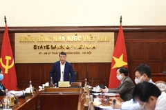 Thống đốc Ngân hàng Nhà nước Lê Minh Hưng chỉ đạo tại Hội nghị trực tuyến. (Ảnh: CTV/Vietnam+)