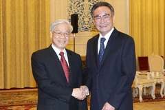 Ủy viên trưởng Ngô Bang Quốc đón Tổng Bí thư Nguyễn Phú Trọng. (Ảnh: Trí Dũng/TTXVN)