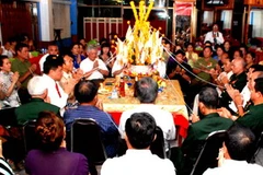 Quang cảnh buổi giao lưu với lễ buọc chỉ cổ tay truyền thống của Lào. (Ảnh: Hoàng Chương/Vietnam+)