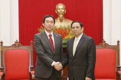 Trưởng Ban Tổ chức Trung ương Phạm Minh Chính tiếp ông Tana CaIu, Phó Trưởng Ban Bí thư Trung ương Đảng Cộng sản Nhật Bản. (Ảnh: Phương Hoa/TTXVN)