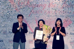 Ông Nguyễn Bảo Hoàng – Chủ tịch Công ty Truyền thông Tương tác, Forbes Việt Nam và bà Chu Thị Thu Hằng, Tổng biên tập báo Văn hóa trao giải thưởng “Thành tựu trọn đời” cho bà Mai Kiều Liên – Tổng Giám đốc Vinamilk. (Ảnh: Lý Võ Phú Hưng/Vietnam+)