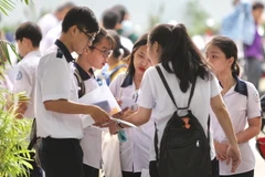 Các thí sinh trao đổi sau khi hoàn tất phần thi môn Toán tại Hội đồng thi trường THCS Collette, quận 3. TP. Hồ Chí Minh. (Ảnh: Quang Nhựt - TTXVN)