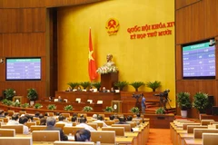 Biểu quyết thông qua Luật Thỏa thuận quốc tế. (Ảnh: Doãn Tấn/TTXVN)