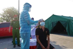 Tài xế được xét nghiệm nhanh tại chốt kiểm soát dịch bệnh tại Trạm thu phí Pháp Vân-Cầu Giẽ. (Ảnh: PV/Vietnam+)