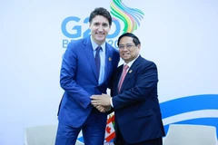 Thủ tướng Phạm Minh Chính gặp Thủ tướng Canada Justin Trudeau. (Ảnh: Dương Giang/TTXVN)