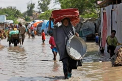 Người dân sơ tán khỏi vùng ngập lụt sau những trận mưa lớn tại Mogadishu, Somalia. (Ảnh: AFP/TTXVN)