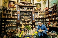 Nhà sưu tập Nguyễn Hiếu Tín với bộ sưu tập Ông Địa độc đáo. (Ảnh: Hồng Đạt/TTXVN)