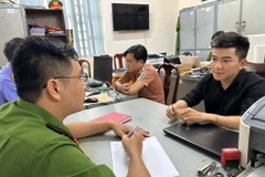 Cơ quan Điều tra lấy lời khai các đối tượng. (Ảnh: Đình Biên/TTXVN phát)