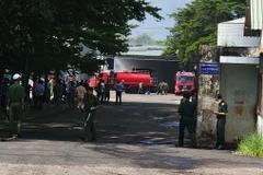 Các lực lượng chức năng thực hiện nhiệm vụ tại hiện trường vụ cháy. (Ảnh: Đậu Tất Thành/TTXVN)