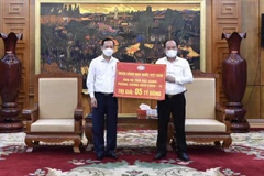 Phó Thống đốc NHNN Đào Minh Tú trao ủng hộ cho lãnh đạo tỉnh Bắc Giang (Ảnh: CTV/Vietnam+)