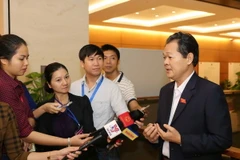 Phóng viên phỏng vấn đại biểu Quốc hội bên lề một phiên họp của Kỳ họp thứ hai, Quốc hội khóa XIV. (Ảnh: Phương Hoa/TTXVN)