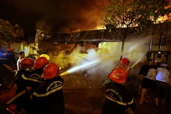 Lực lượng chữa cháy tiến hành dập lửa. (Ảnh: Phạm Kiên/TTXVN)