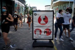 Một biển báo khuyến cáo cách phòng dịch COVID-19 trên phố ở Brussels (Bỉ). (Ảnh: THX/TTXVN)