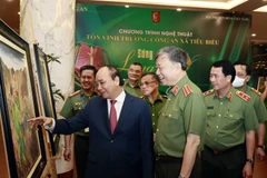 Chủ tịch nước Nguyễn Xuân Phúc dự Chương trình giao lưu nghệ thuật Sống trong lòng dân tôn vinh Trưởng Công an xã tiêu biểu. (Ảnh:Thống Nhất/TTXVN)