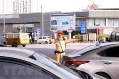Lực lượng cảnh sát giao thông phân luồng, điều tiết giao thông. (Ảnh: Phạm Kiên/TTXVN) 