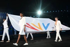 Các vận động viên mang cờ của Liên đoàn Đại hội thể thao Khối thịnh vượng chung trong lễ khai mạc Đại hội thể thao Khối thịnh vượng chung ở Birmingham, miền trung nước Anh, ngày 28/7/2022. (Ảnh: Andy Buchanan/AFP)