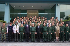Thượng tướng Nguyễn Chí Vịnh và các chuyên gia chụp ảnh lưu niệm. (Ảnh: Dương Giang/TTXVN)