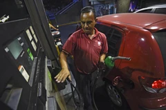 Nhân viên bơm xăng tại một trạm xăng ở thủ đô Caracas. (Nguồn: AFP/TTXVN)