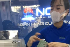Hoạt động nghiệp vụ tại Ngân hàng TMCP Quốc dân. (Ảnh: Trần Việt/TTXVN)