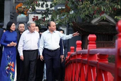 Chủ tịch nước Nguyễn Xuân Phúc cùng Tổng Thư ký Liên hợp quốc António Guterres trên cầu Thê Húc, hồ Hoàn Kiếm. (Ảnh: Thống Nhất/TTXVN)