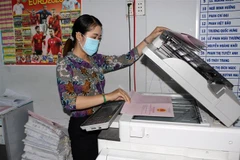 Cán bộ Văn phòng đăng ký đất đai thành phố Bạc Liêu thực hiện các biện pháp nghiệp vụ cấp giấy chứng nhận quyền sử dụng đất. (Ảnh: Tuấn Kiệt/TTXVN)