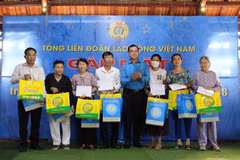 Ông Nguyễn Đình Khang, Chủ tịch Tổng liên đoàn Lao động Việt Nam trao quà và 5 triệu tiền mặt cho thân nhân các liệt sĩ đã hy sinh tại trận chiến đấu bảo vệ đảo Gạc Ma tại huyện Cam Lâm. (Ảnh: Phan Sáu/TTXVN)