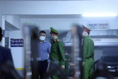 Lực lượng chức năng tới trụ sở Công ty Cổ phần Chứng khoán Trí Việt thực hiện việc khám xét ngày 20/4. (Ảnh: Phạm Kiên/TTXVN)