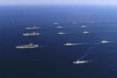 Tàu sân bay USS Ronald Reagan (trái, giữa), tàu USS Nimitz (trái, phía trên) và tàu USS Theodore Roosevelt của Mỹ tham gia tập trận hải quân chung với tàu khu trục của Hàn Quốc (giữa, phía trên và dưới) ở Biển Đông. (Ảnh: AFP/TTXVN)