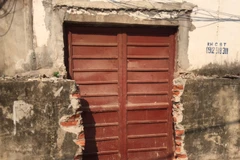 Tường bao của khu tập thể bị đập phá, mở thành cửa để đi lại. (Ảnh: Nguyễn Thắng/TTXVN)