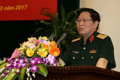 Đại tướng Ngô Xuân Lịch, Ủy viên Bộ Chính trị, Phó Bí thư Quân ủy Trung ương, Bộ trưởng Bộ Quốc phòng chủ trì Hội thảo. (Nguồn: TTXVN)