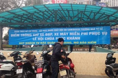 Người dân tới lễ chùa được hướng dẫn tới địa điểm trông giữ xe cách đó 200m, nằm ở vườn hoa Ngã Tư Sở. (Ảnh: Sơn Bách/Vietnam+)