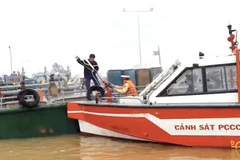 Canô cùng lực lượng chữa cháy tiếp cận tàu chở xăng sáng 6/9. (Ảnh: TTXVN phát)