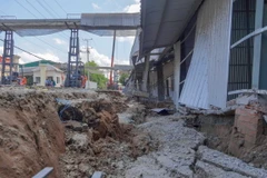 Nhà kho của Công ty Lương thực Hưng Phước bị sụt lún sâu so với mặt đường tỉnh 921. (Ảnh: Thanh Liêm/TTXVN)
