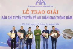 Thiếu tướng Nguyễn Duy Ngọc, Thứ trưởng Bộ Công an, Phó Chủ tịch Ủy ban An toàn giao thông Quốc gia trao giải Nhì cho các tác giả. (Ảnh: Doãn Tấn/TTXVN)