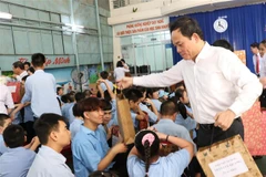 Phó Thủ tướng Trần Lưu Quang tặng quà cho các em học sinh ở Trung tâm Phục hồi chức năng - Giáo dục trẻ em khuyết tật tỉnh Khánh Hòa. (Ảnh: Phan Sáu/TTXVN)