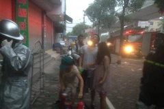 Hai nạn nhân được Cảnh sát PCCC hỗ trợ thoát ra ngoài an toàn. (Ảnh: Cơ quan chức năng cung cấp) 