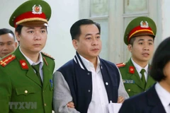 Cảnh sát dẫn giải bị cáo Phan Văn Anh Vũ. (Ảnh: Doãn Tấn/TTXVN)