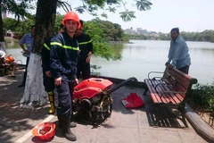 Địa điểm cháy nằm ngay cạnh tổ hợp ăn uống 'hàm cá mập' và rất khó tiếp cận. Lực lượng chữa cháy phải dùng tới nước Hồ Gươm để dập lửa. (PV/Vietnam+)
