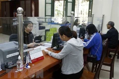 Giải quyết thủ tục, chế độ bảo hiểm xã hội cho người lao động. (Ảnh minh họa. Phạm Kiên/TTXVN)