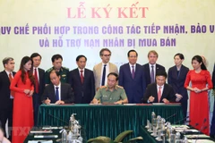 Lễ ký kết quy chế phối hợp trong công tác tiếp nhận, bảo vệ và hỗ trợ nạn nhân bị mua bán. (Ảnh: Hoàng Hiếu/TTXVN)