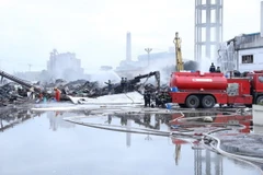 Lực lượng thuộc Phòng Cảnh sát Phòng cháy chữa cháy và Cứu nạn cứu hộ Công an tỉnh Ninh Bình phun nước khống chế vụ cháy. (Ảnh: Đức Phương/TTXVN)