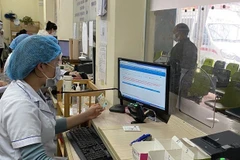 Người dân làm thủ tục khám chữa bệnh bằng thẻ căn cước công dân gắn chíp. (Ảnh: PV/Vietnam+) 