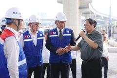Thủ tướng Phạm Minh Chính trao đổi với đơn vị thi công Dự án xây dựng tuyến đường sắt đô thị số 1 (Bến Thành-Suối Tiên). (Ảnh: Dương Giang/TTXVN) 
