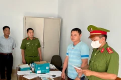 Đối tượng Nguyễn Thành Trung (áo xanh sọc ngang). (Ảnh: TTXVN phát)