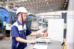 Kỹ sư Nguyễn Văn Tuân kiểm tra tỷ trọng cáp điện, một trong những hoạt động của nghiên cứu để giảm tỷ trọng lõi dẫn, giảm giá thành sản xuất cáp điện. (Ảnh: Minh Thu/TTXVN)