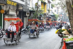 Đoàn khách du lịch quốc tế tham quan phố cổ Hà Nội. (Ảnh: Minh Quyết/TTXVN)