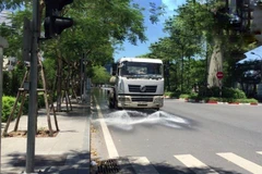 Công ty TNHH MTV Môi trường Đô thị Hà Nội, Chi nhánh Đống Đa thực hiện tưới nước làm mát, giảm bụi tại tuyến đường Hoàng Cầu (Đống Đa) trong những ngày nắng nóng. (Ảnh Minh Nghĩa/TTXVN)