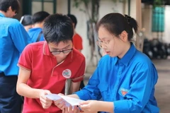 Lực lượng thanh niên tình nguyện hỗ trợ thí sinh tại điểm thi Trường Trung học Phổ thông Thăng Long (quận Hai Bà Trưng). (Ảnh: Hoàng Hiếu/TTXVN)