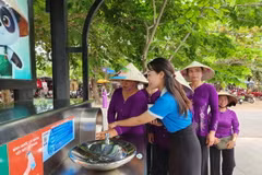 Du khách lấy nước miễn phí tại trạm nhà chờ và máy cấp nước. (Ảnh: Tường Vi/TTXVN)